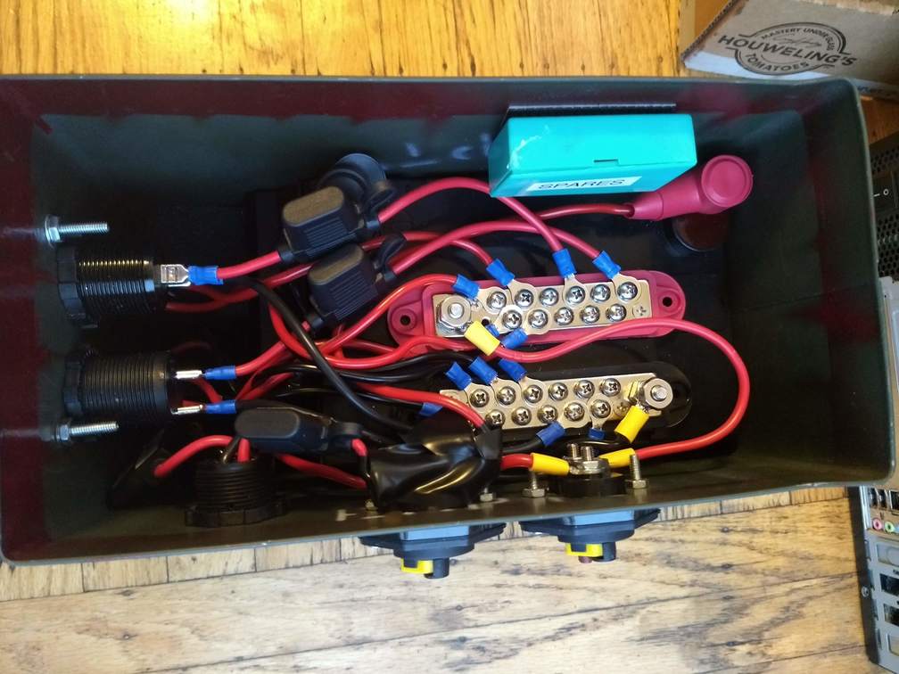 A rat's nest of wires inside the battery box