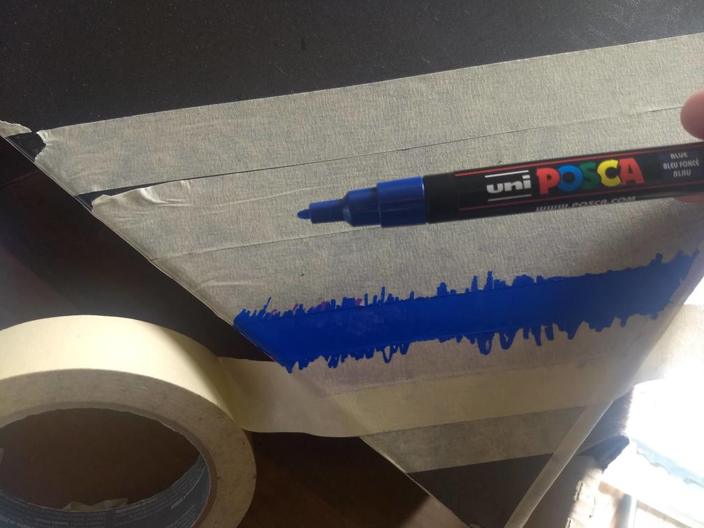 The blue stripe of the rainbow-in-progress, surrounded by masking tape