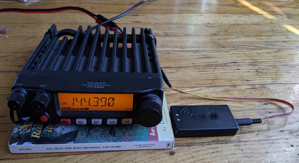 An amateur radio connected to a smaller box with a home-built cable.
